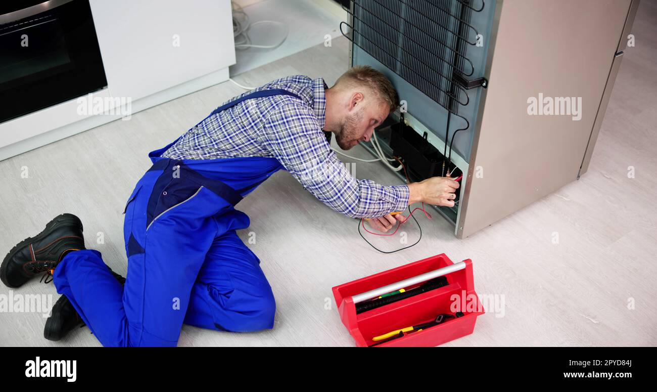 Testing Electric Appliance Using Multimeter To Repair Fridge Stock