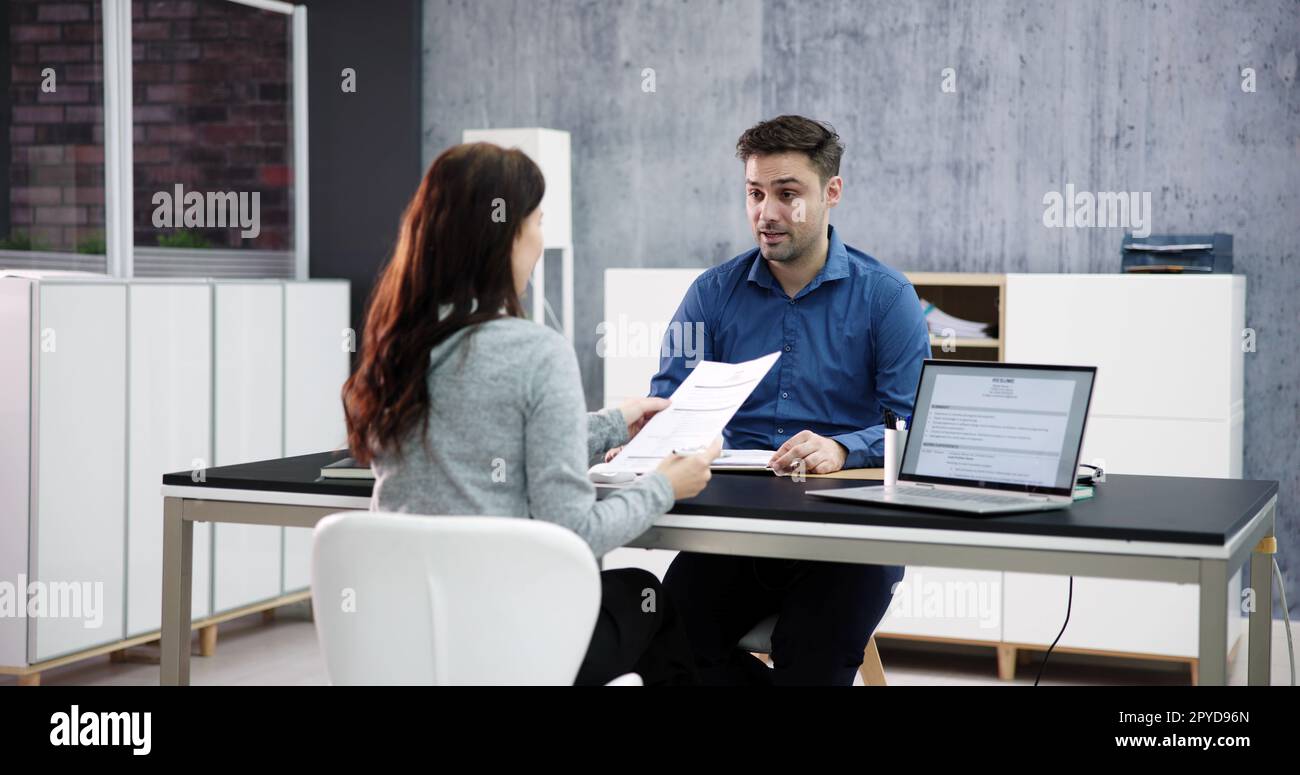 Two Businesspeople Talking With Each Other Stock Photo