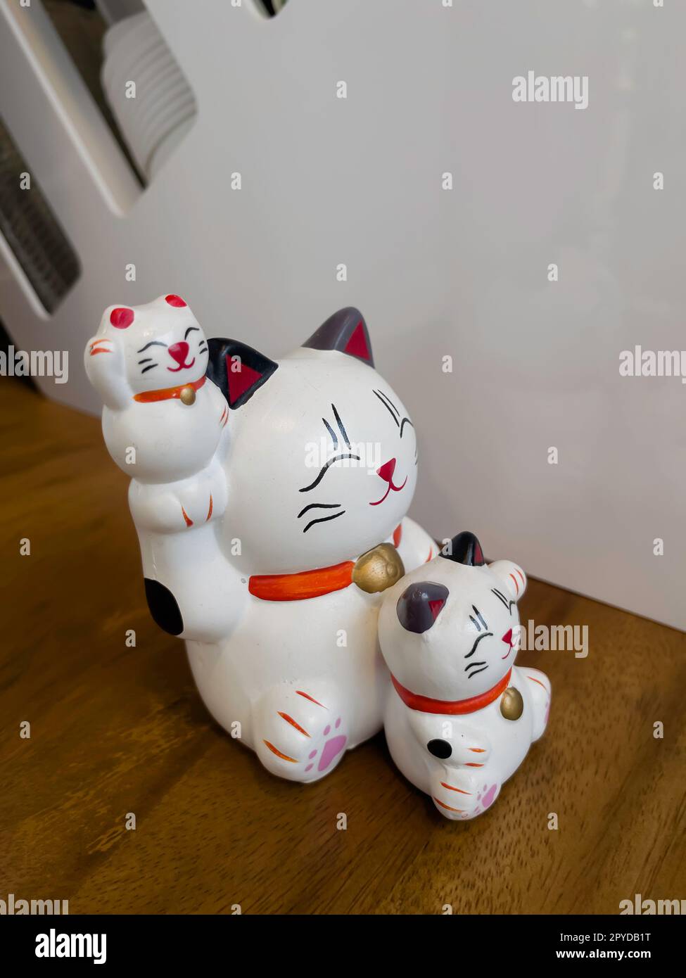 Lucky cat standing and holding Stock Photo
