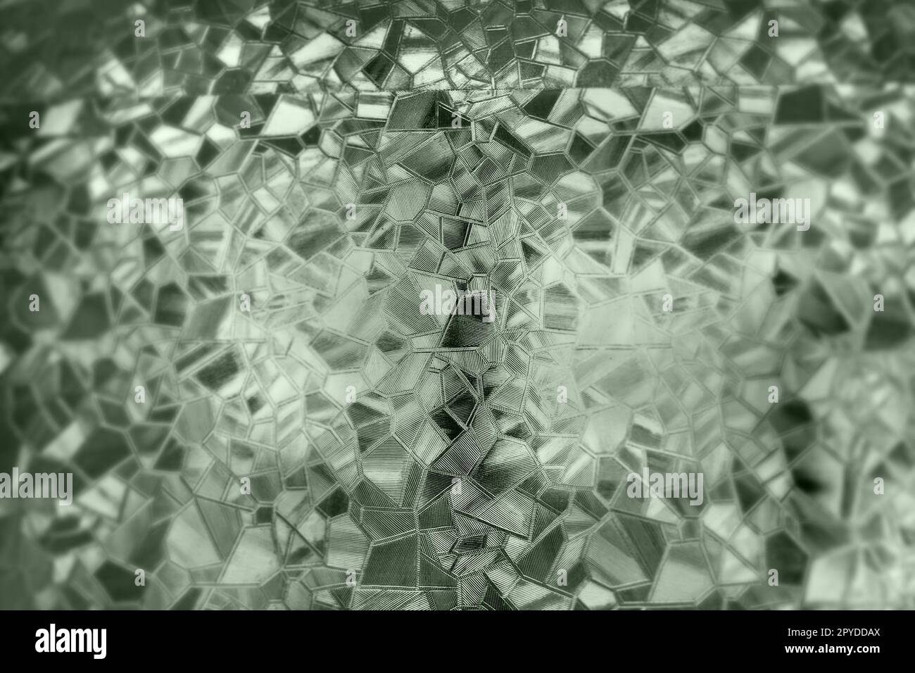 Corrugated glass green background. Abstract pattern on the surface of a window. Protective opaque film. Stock Photo