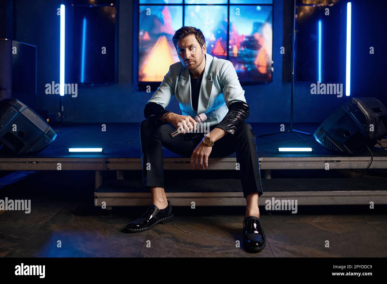 Cropped shot of male pop singer hand holding microphone Stock Photo