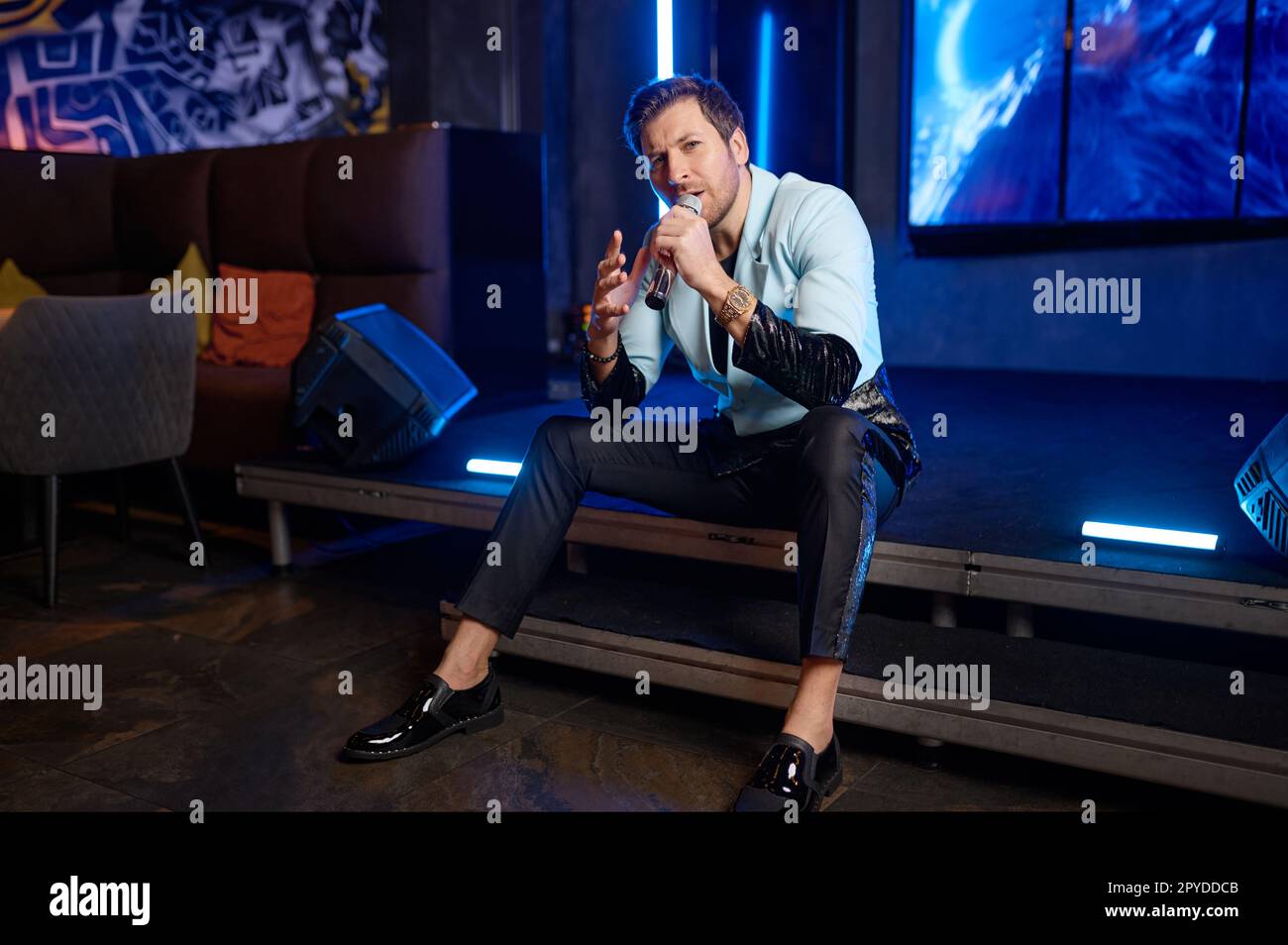 Male singer performing on stage at music concert Stock Photo Alamy