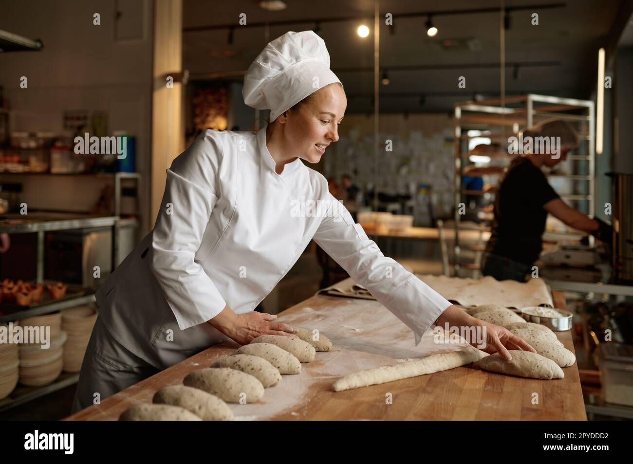 professional bread baker in bakery shop and posing with shelf with uncooked  raw bread knead on shovel. concept of traditional manual bread preparation  Stock Photo - Alamy