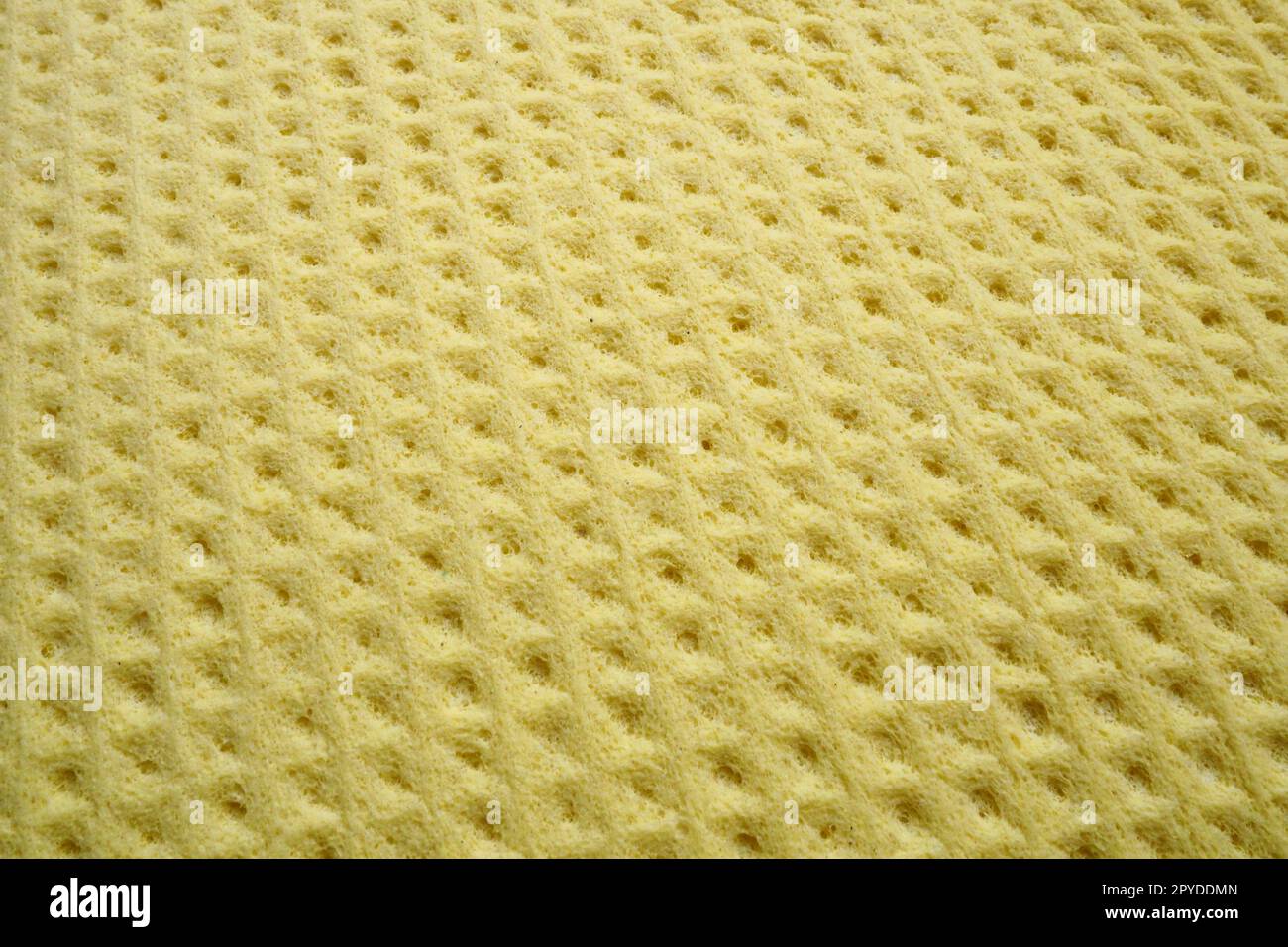 Sponge fibers sponge texture pattern surface close-up yellow background Stock Photo