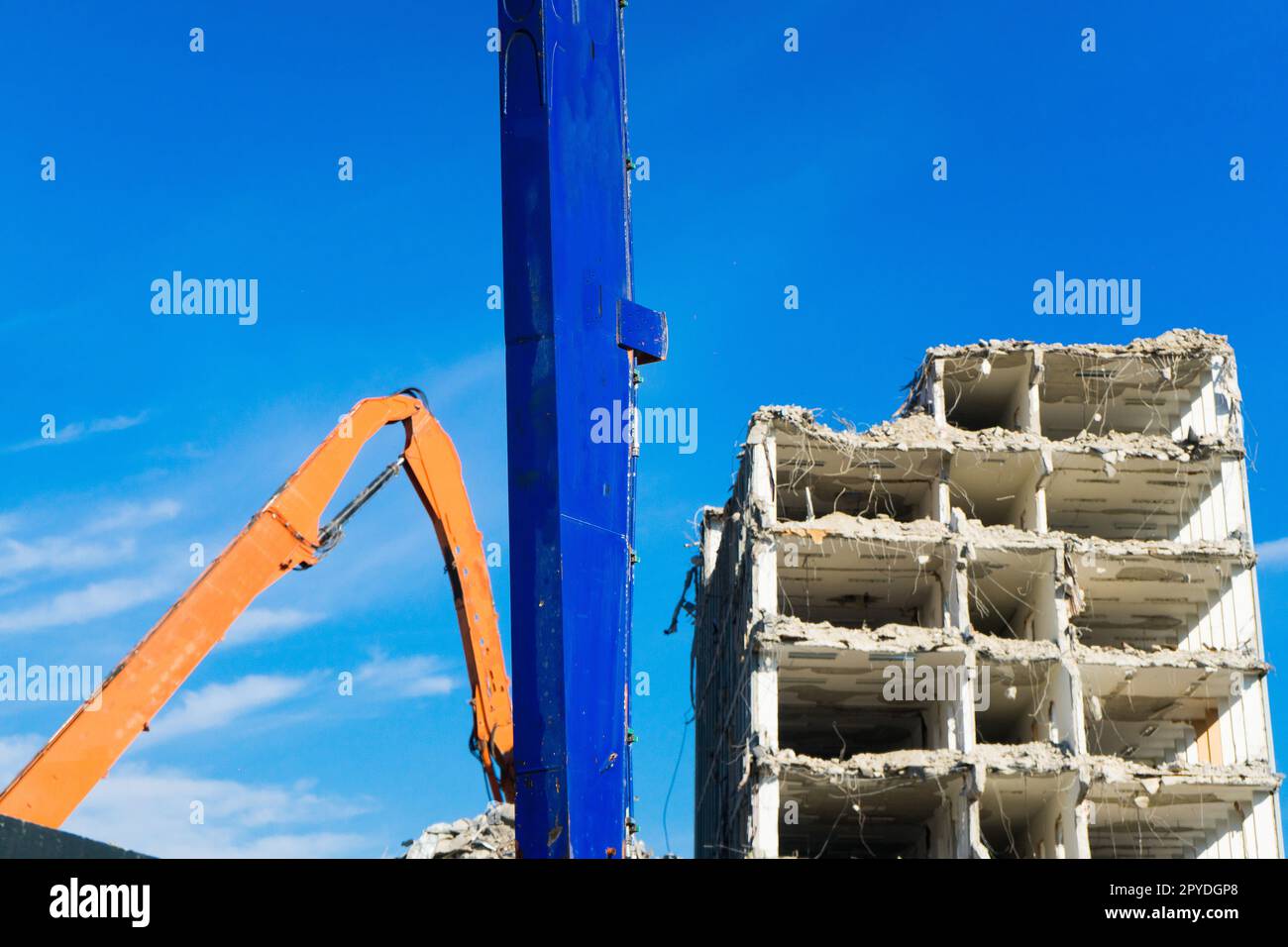 Construction site digger yellow demolishing house for reconstruction Stock Photo