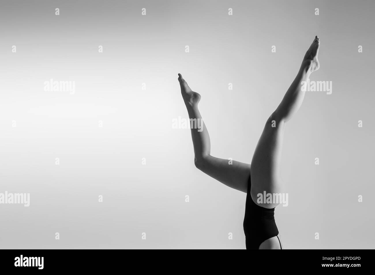 Athletic woman in swimsuit, doing yoga, push-ups, beautiful female exercising at studio Stock Photo