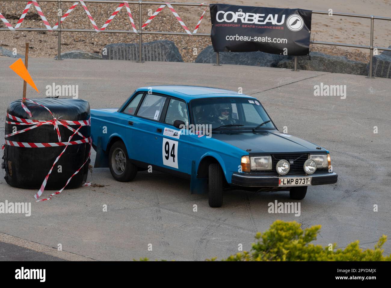 Darrell Denning racing a classic 1979 Volvo 244 competing in the Corbeau Seats rally on the seafront at Clacton, Essex, UK. Co driver Zak Linham Stock Photo