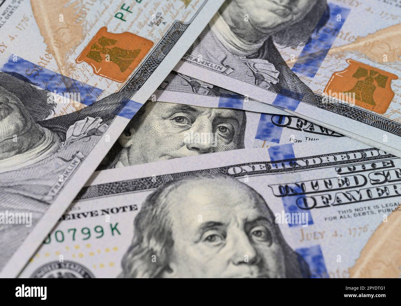 Fragment of one hundred dollar bill with a portrait of Benjamin Franklin under a magnifying glass, eye Stock Photo