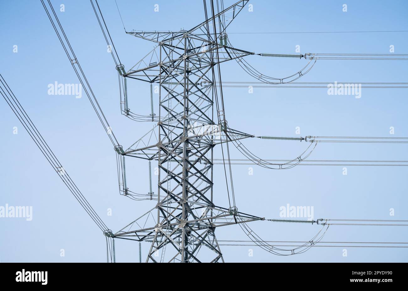 High voltage electric transmission tower. High voltage power lines against the sky. Electricity pylon and electric power transmission lines. High Voltage tower provide power supply. Energy crisis. Stock Photo