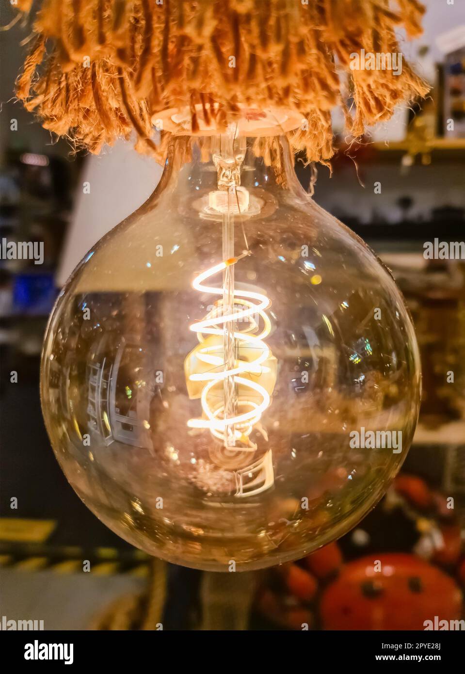 Close-up of a vintage light bulb with soft background. Stock Photo