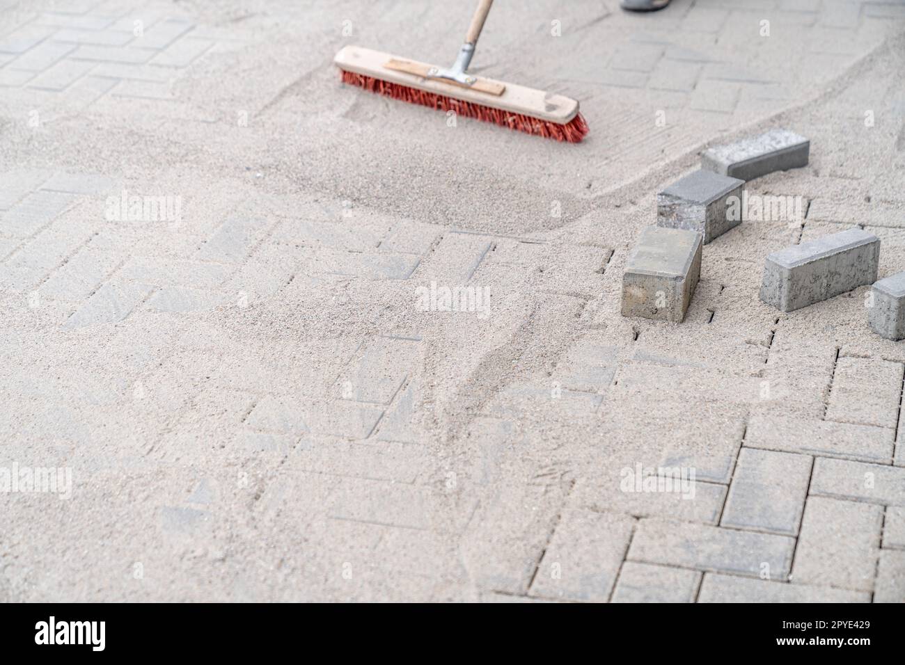 filling the gaps in the new pavement with sand Stock Photo Alamy