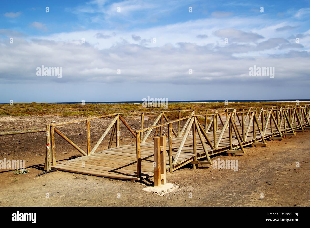 Through a wooden walkway, beachgoers are guided through the nature worth protecting without damaging it. Stock Photo