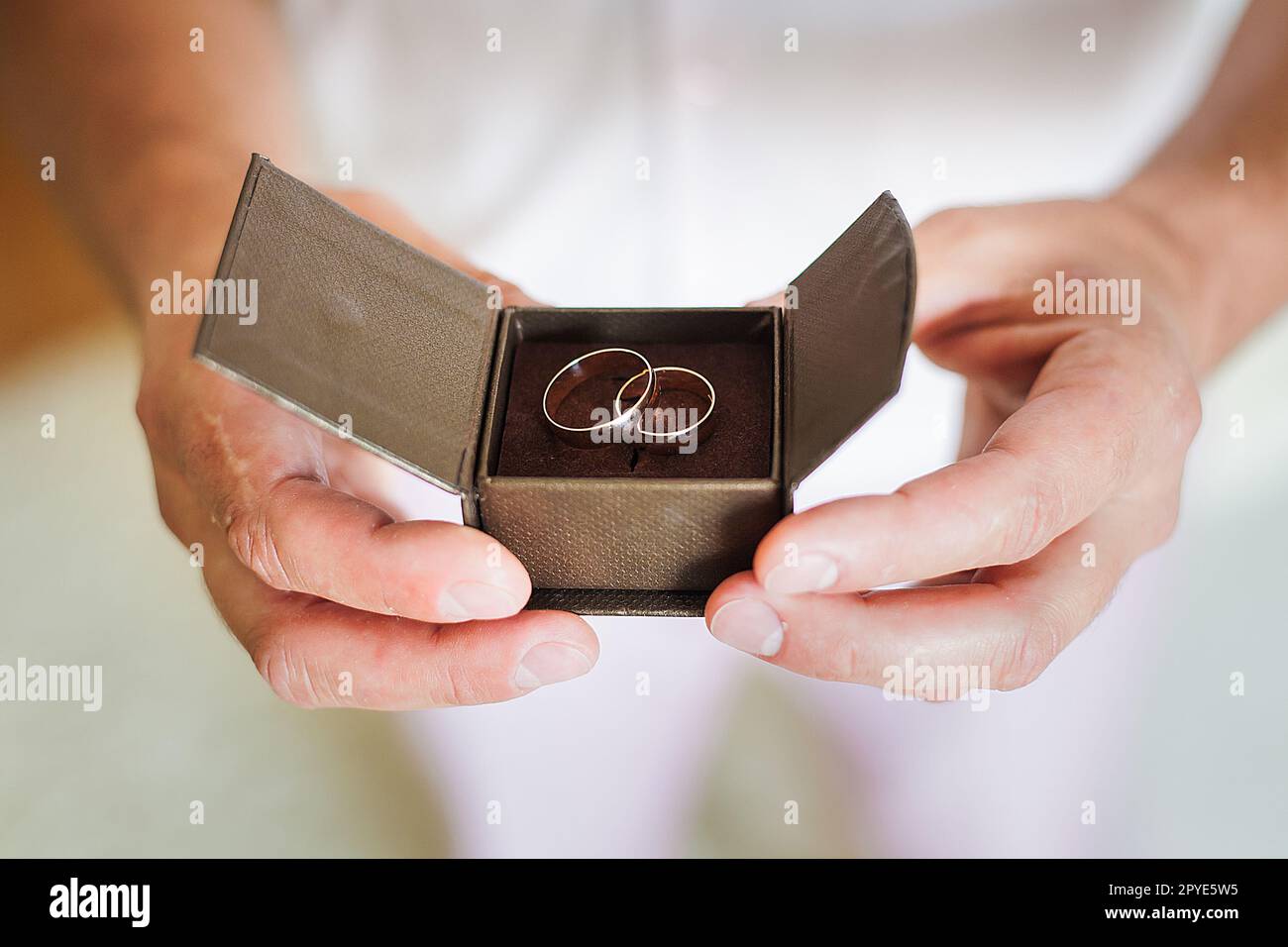 groom holding beautiful box with wedding rings Stock Photo