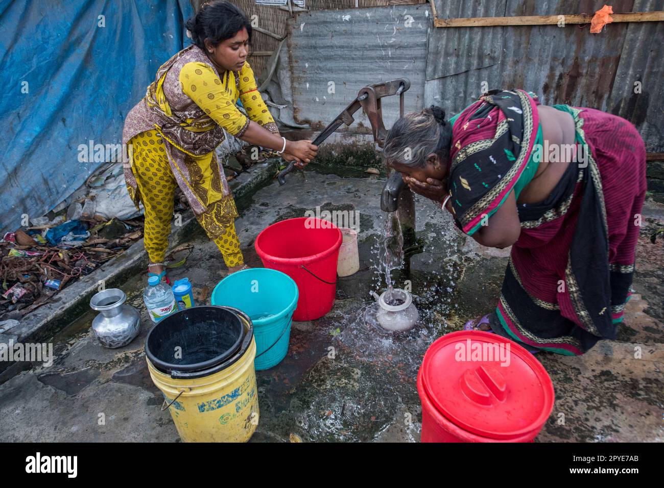 Bangladesh, Khulna, Sonadanga. Two women gather water from the local pump in Bangladesh. March 19, 2017. Editorial use only. Stock Photo