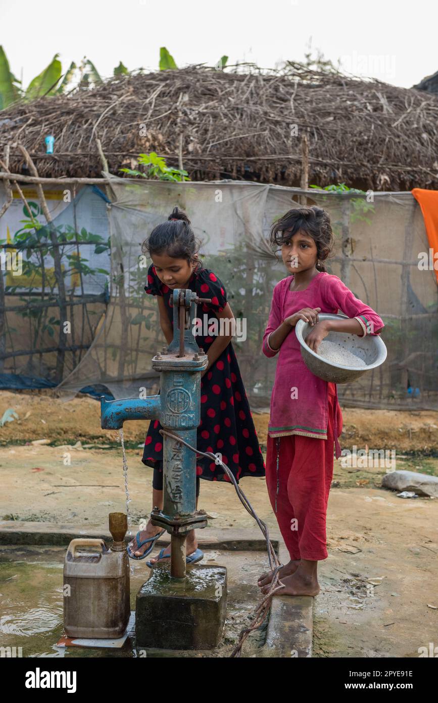 Bangladesh, Cox's Bazar. Children gather water in the Kutupalong Rohingya Refugee Camp. March 24, 2017. Editorial use only. Stock Photo