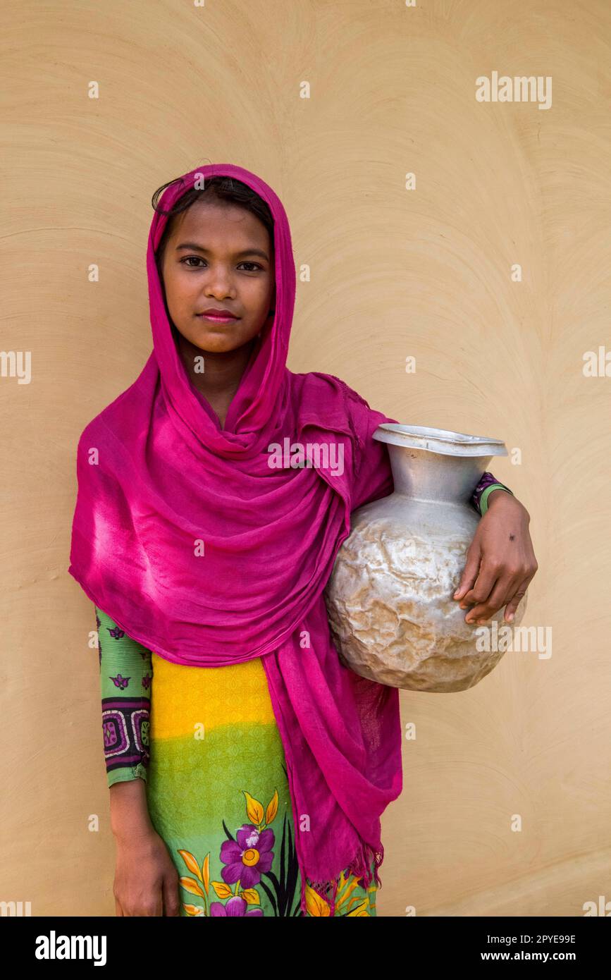 Bangladesh, Teknaf, Cox's Bazar. Portrait of a young girl on her way to collect water at the pump. March 25, 2017. Editorial use only. Stock Photo