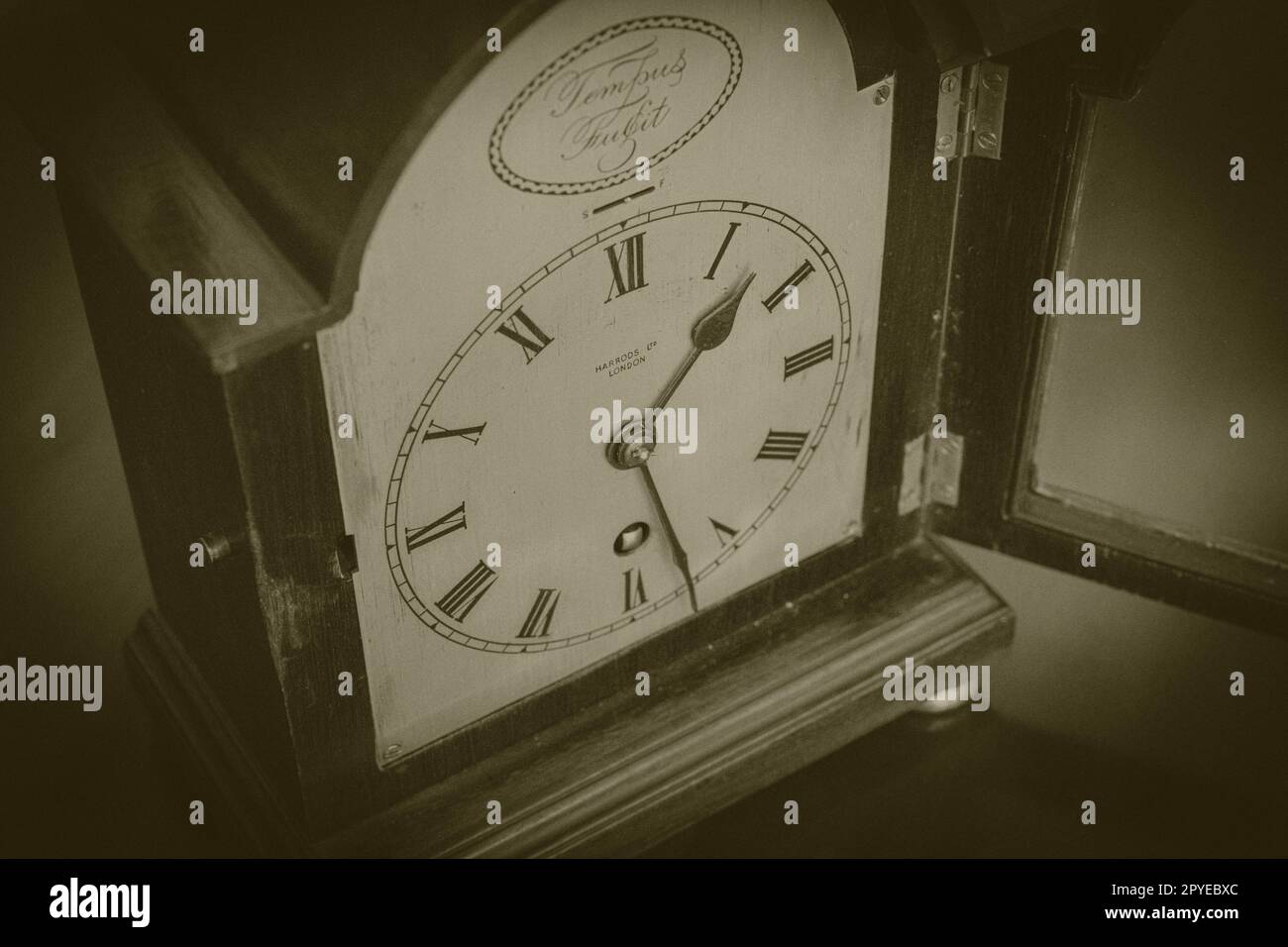 Aged Black and white image of a Harrods of London vintage clock Stock