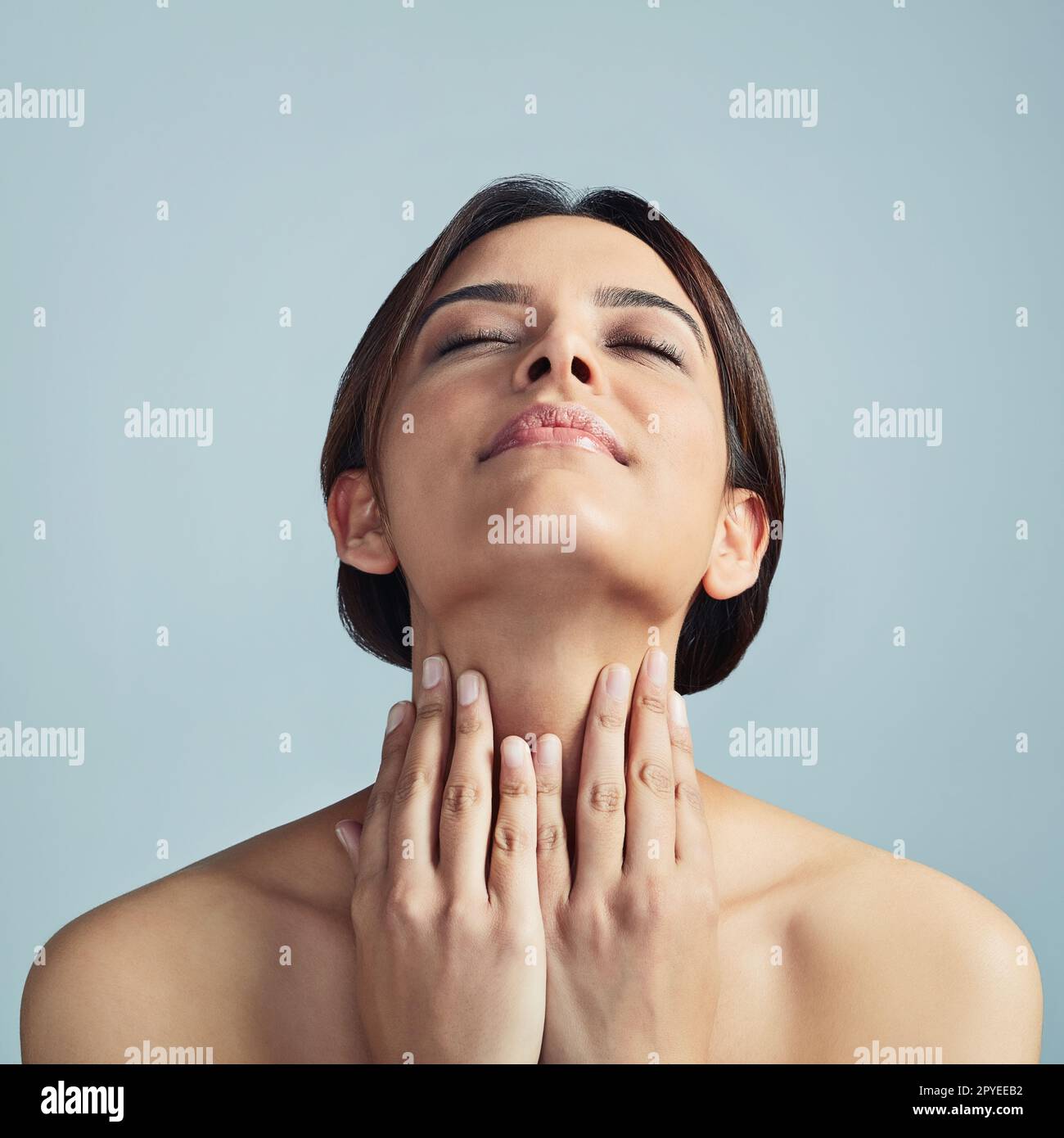 Skincare has never been so easy. a young woman touching her skin ...