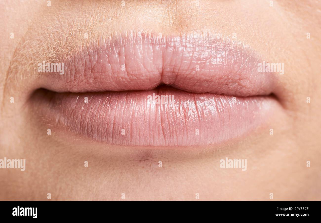 Face, macro and lips of woman with makeup, lipstick and cosmetics. Facial skincare, beauty aesthetics and zoom or extreme closeup of mouth of beautiful albino female with lip filler and healthy skin. Stock Photo