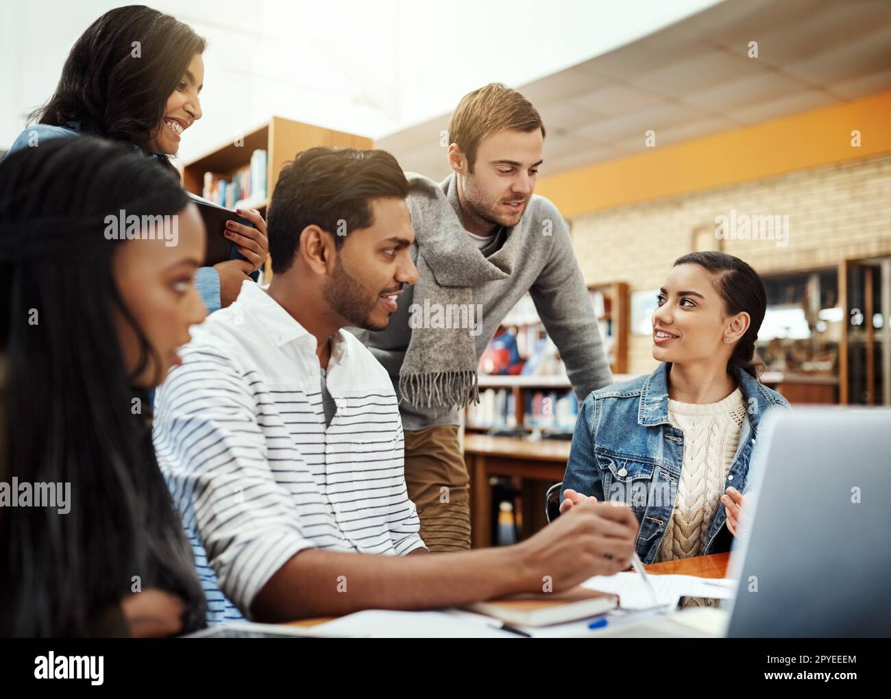Theyve all got their own strengths. a group of university students studying in the library. Stock Photo