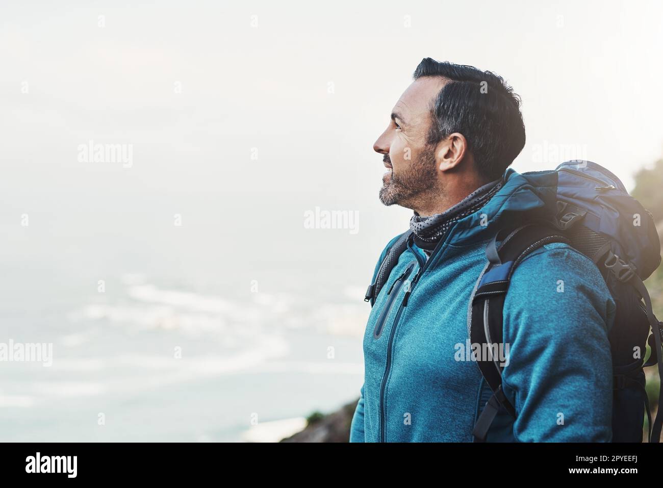 Always be grateful when you reach heights youve never imagined. a middle aged man looking at the view on top of a mountain. Stock Photo