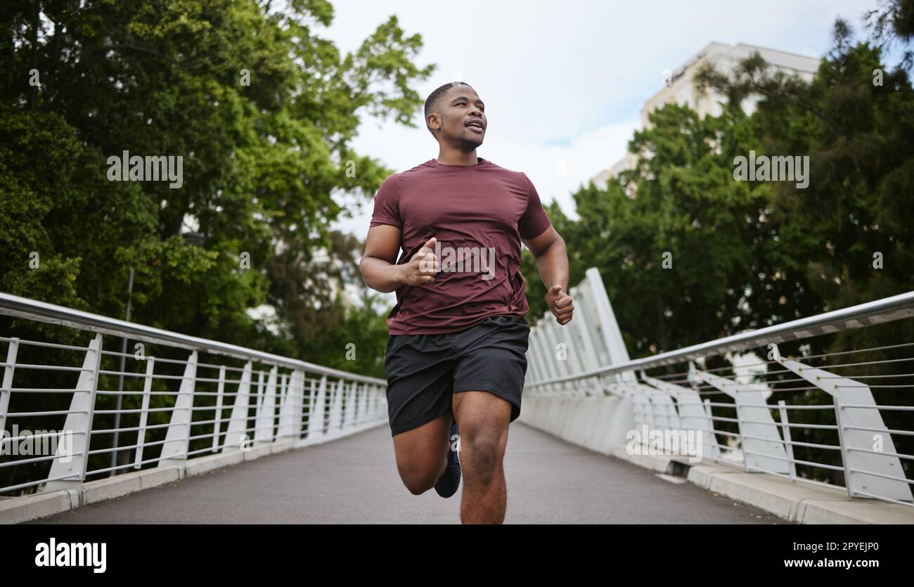 Young African-American black man jogging and running on a path and