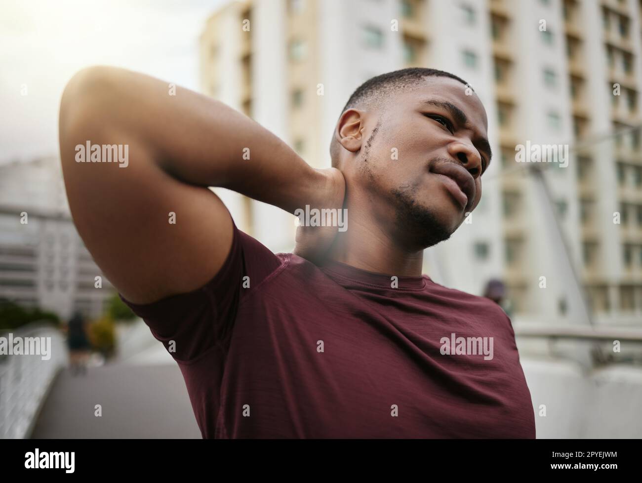 Black man, fitness or neck pain in city workout, training or exercise is muscle burnout, tension stress or body crisis. Runner, sports athlete or personal trainer with injury or running marathon risk Stock Photo