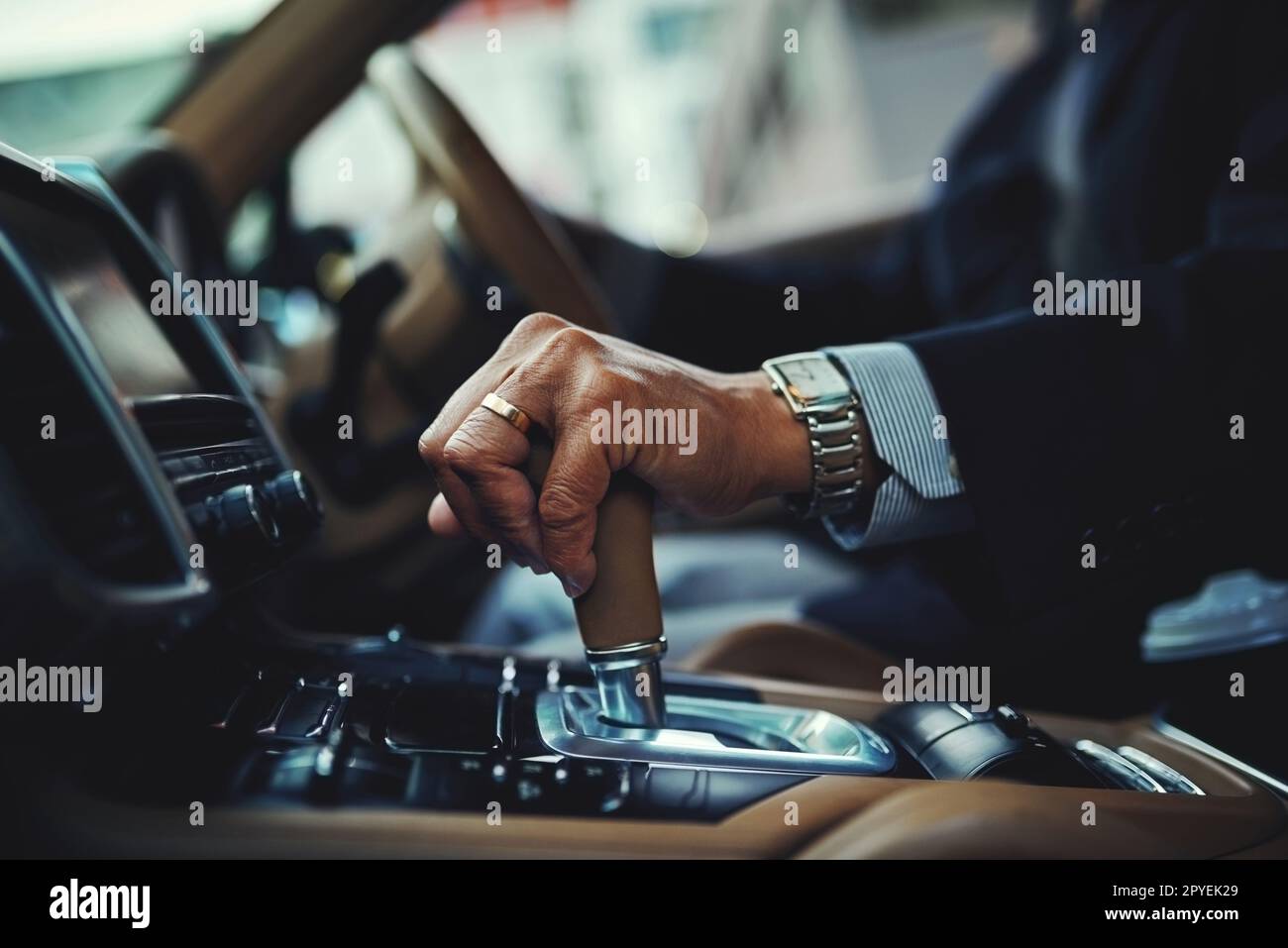 All geared and good to go. a businessman changing the gears of a car