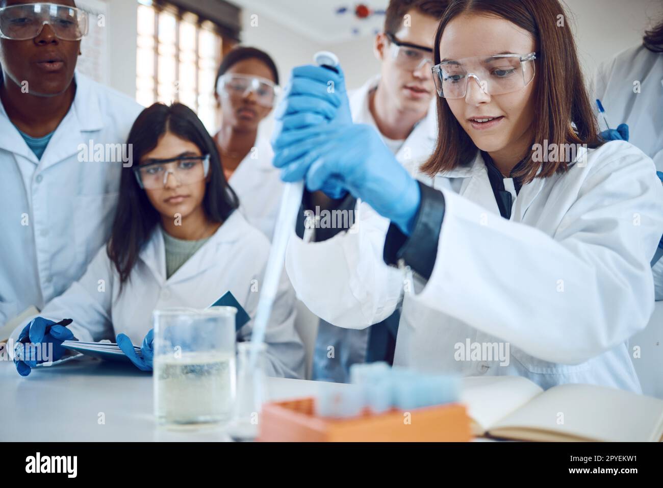 Science research, students and scientist lab for medical innovation, education or knowledge of a group together for learning and analytics . Men and women with scientific chemical for healthcare cure Stock Photo