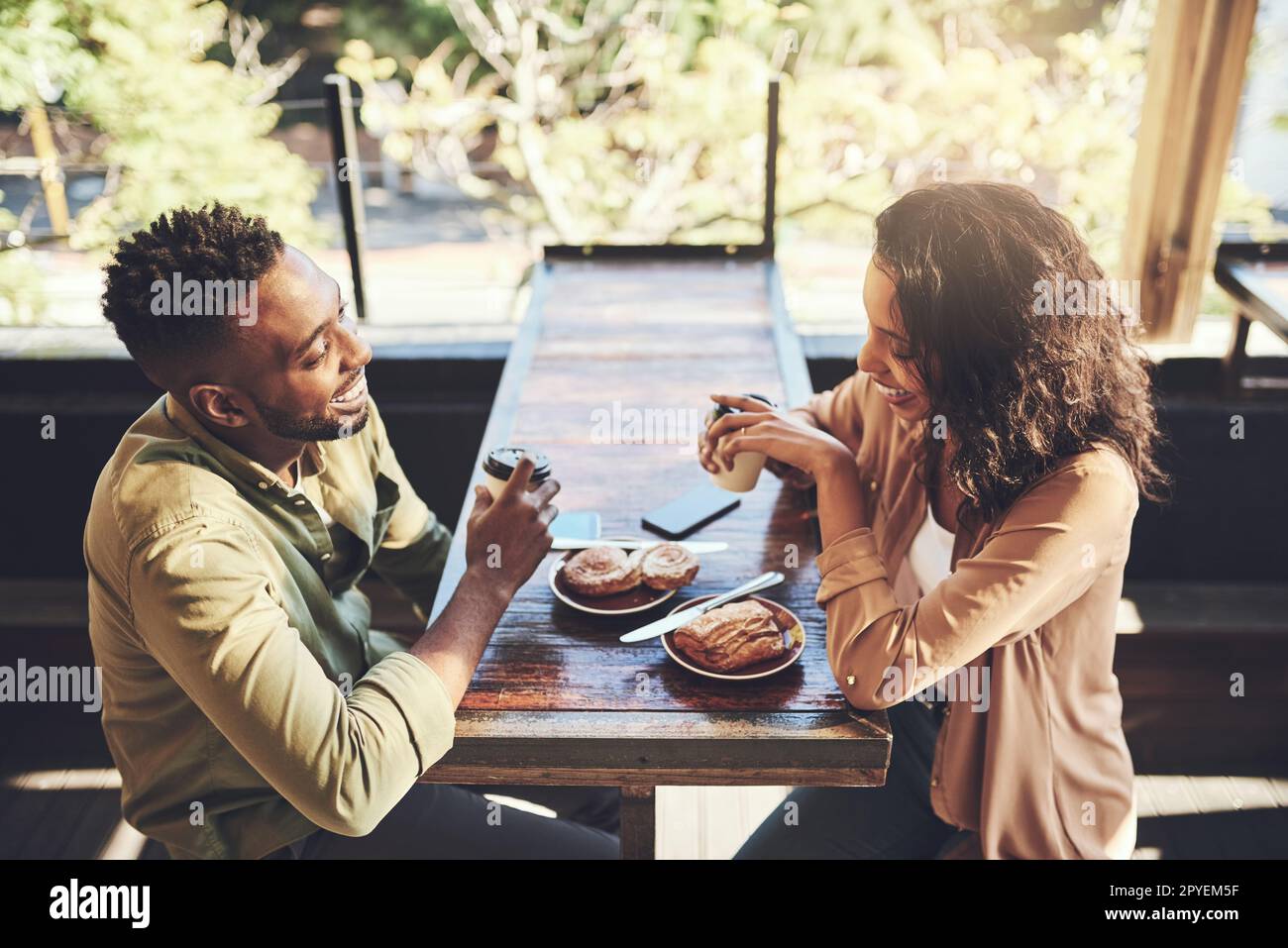 Youre even more beautiful than your dating profile. a young couple having pastries at a coffee shop. Stock Photo