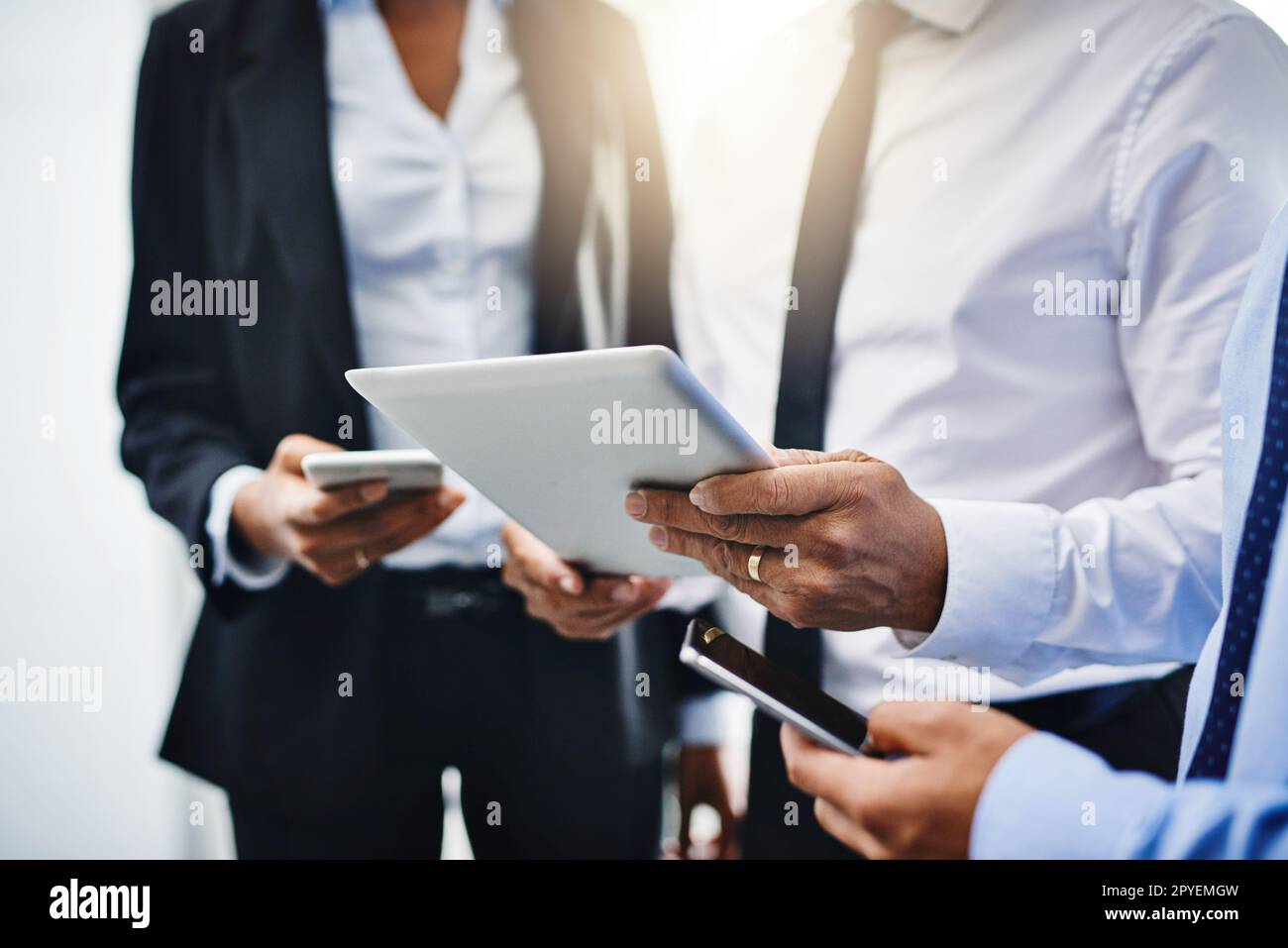 Your success depends on how reachable you are. unrecognizable businesspeople using their wireless devices in the office. Stock Photo