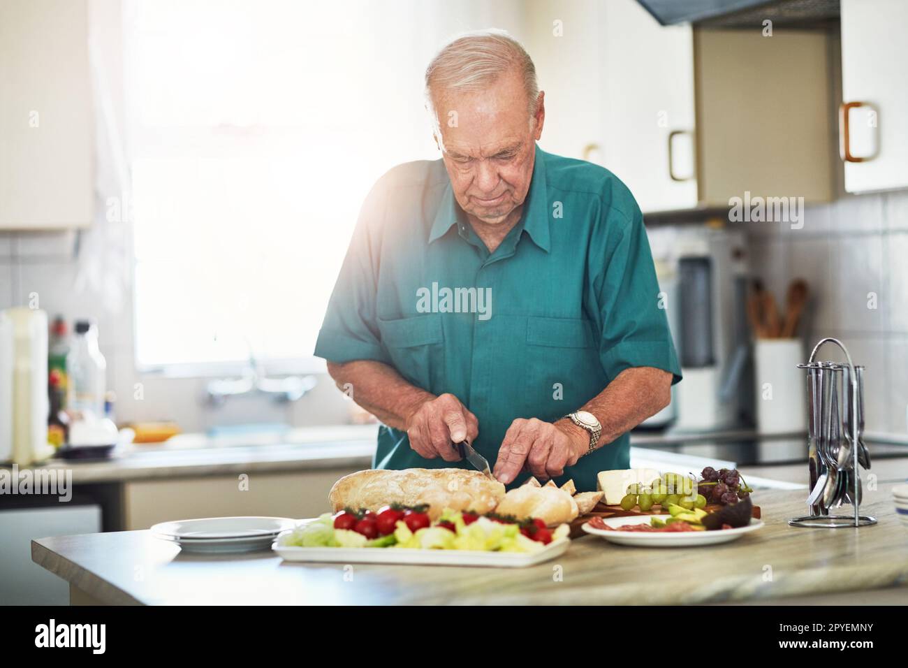 Retirement living at its finest. a senior man making lunch in his kitchen at home. Stock Photo