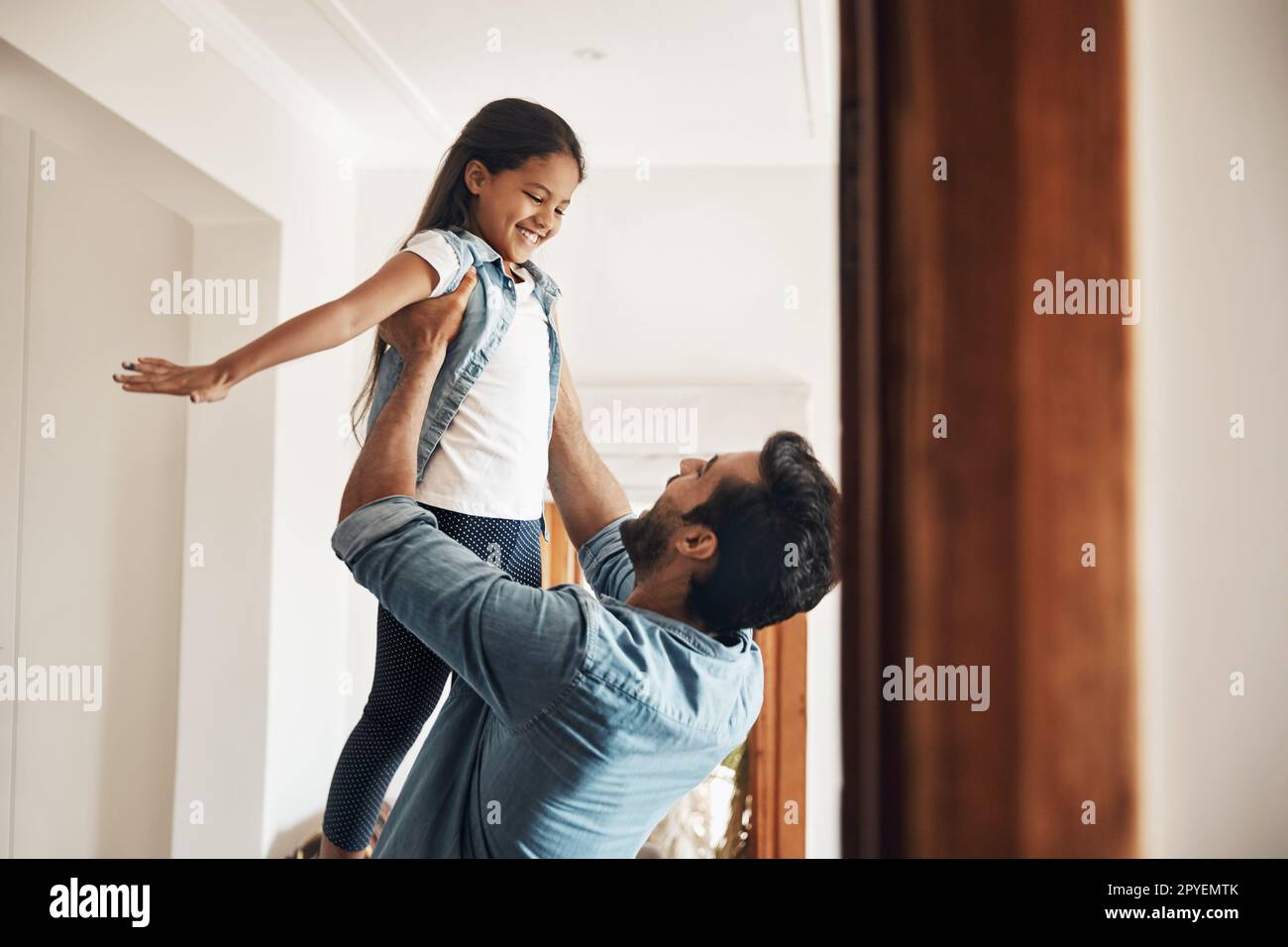 Spending time with dad is so much fun. a happy father and daughter playing together at home. Stock Photo