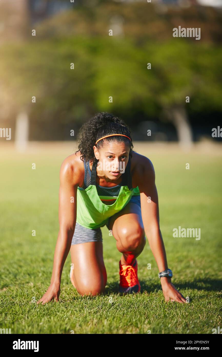 Start and end with determination. a sporty young woman exercising outdoors. Stock Photo
