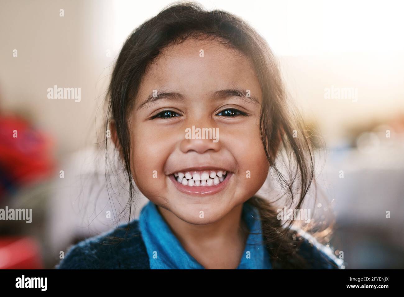 Turning into a big girl. Portrait of a cheerful little girl playing around at home while smiling all the way inside during the day. Stock Photo