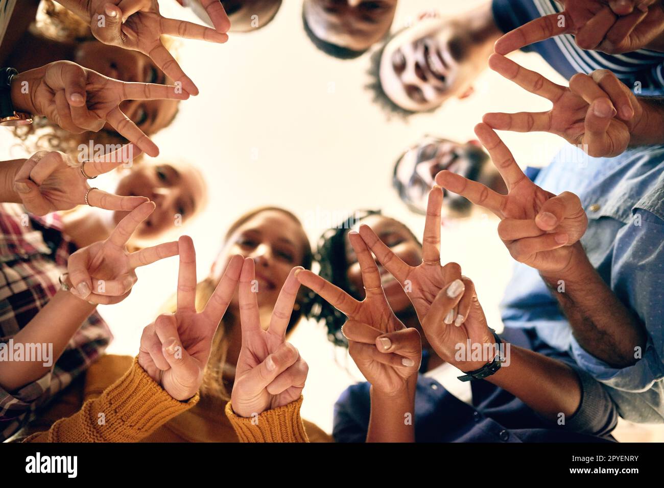 Spread the peace. Low angle shot of a group of people joining their hands together. Stock Photo