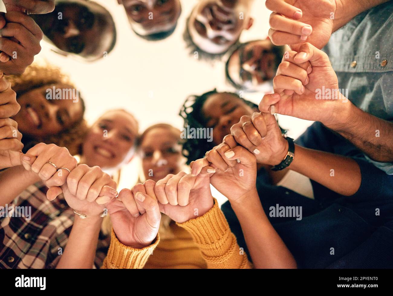 Hands of strength and support. Low angle shot of a group of people joining their hands together. Stock Photo