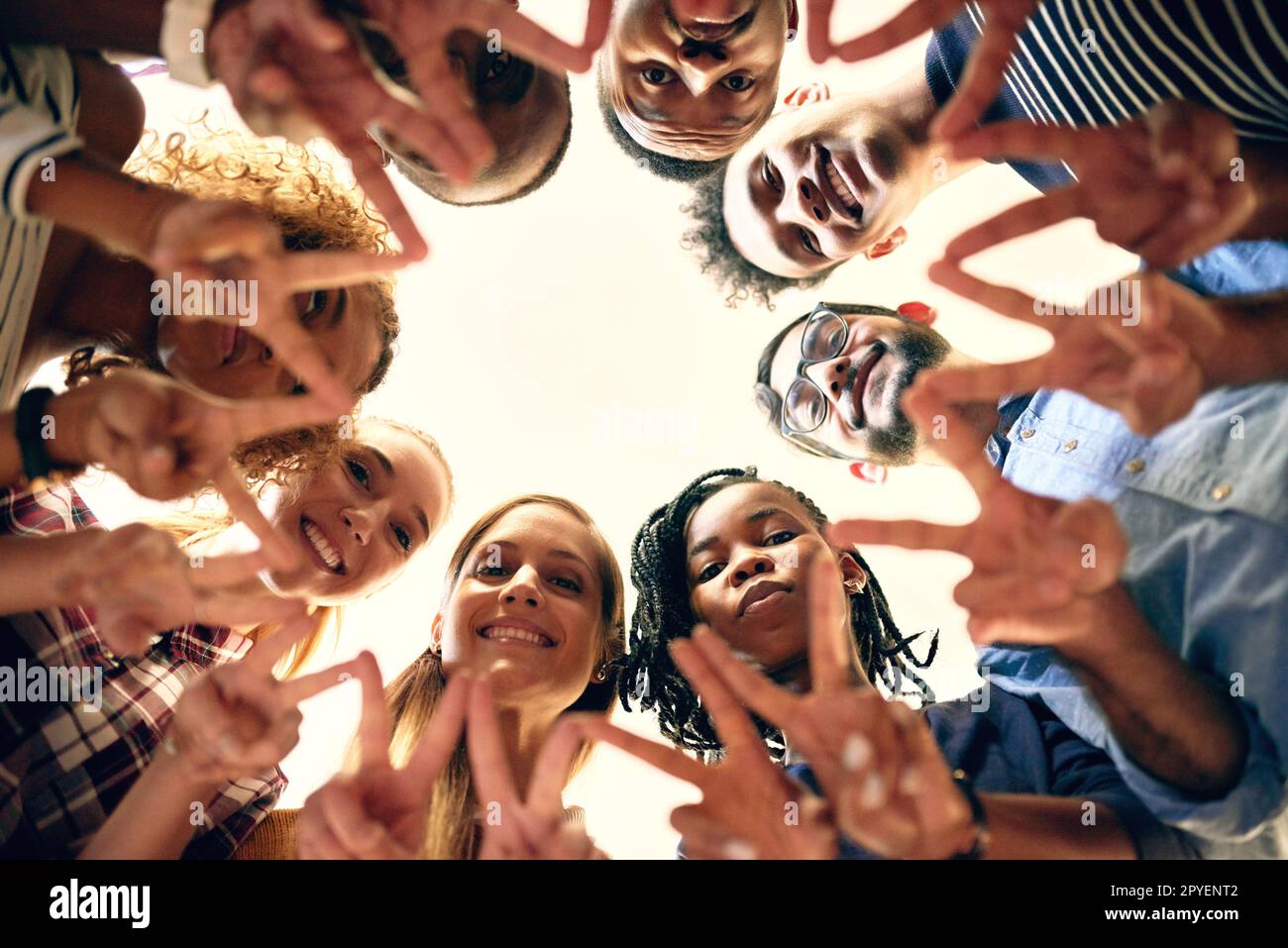 Nothing but peace and love. Low angle shot of a group of people joining their hands together. Stock Photo