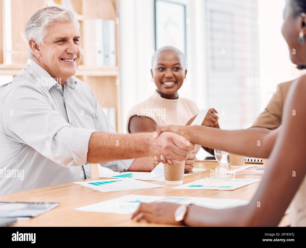 Handshake, hiring or CEO shaking hands with black woman for job interview success meeting in business office. Partnership, thank you or happy senior hr manager with hand shake for congratulations Stock Photo