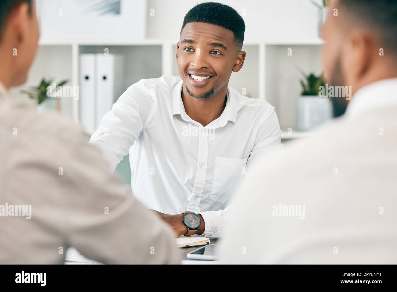 Black man, executive group and handshake in agreement, negotiation and smile for contract at office. Corporate leader, african businessman and shaking hands in office for success, deal and proposal Stock Photo