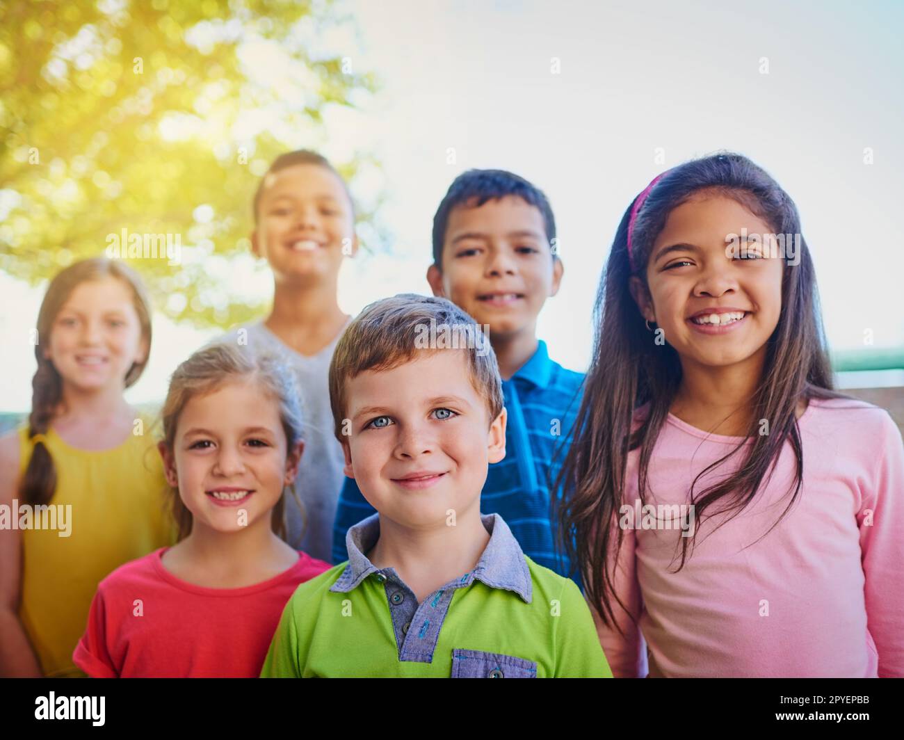 The fun never stops with this bunch. a diverse group of children outside. Stock Photo
