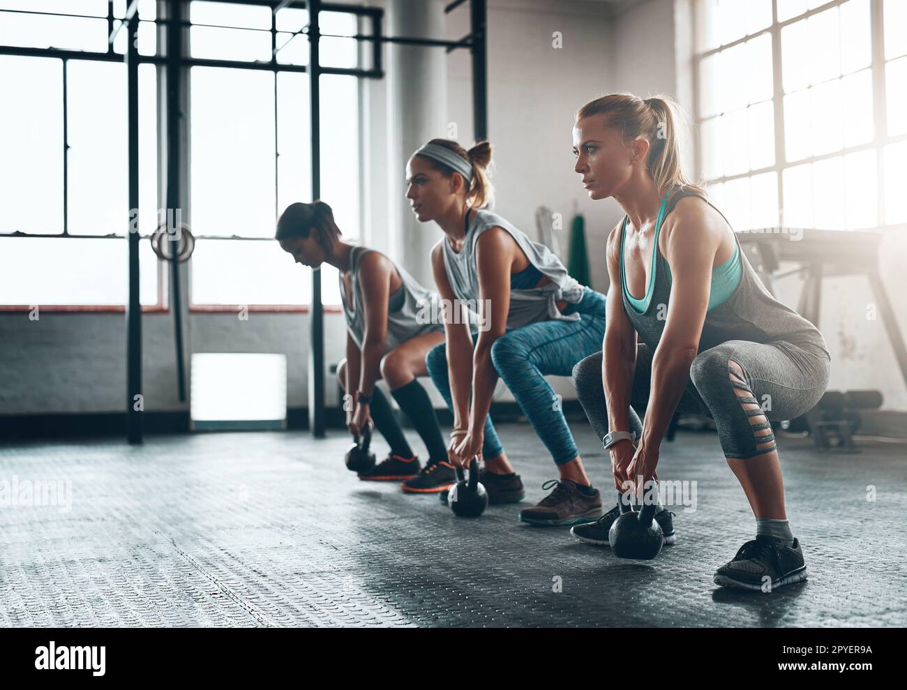 You are stronger than your challenges. three young women working out together. Stock Photo