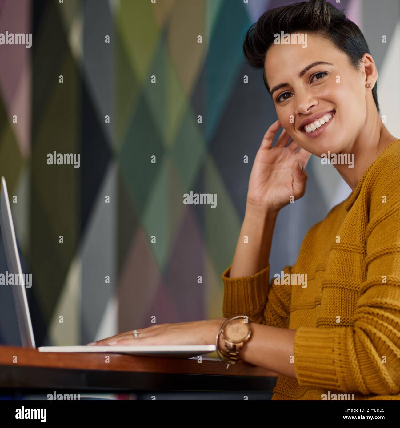 Its been an easygoing workday. Portrait of a confident young businesswoman working on a laptop in an office. Stock Photo