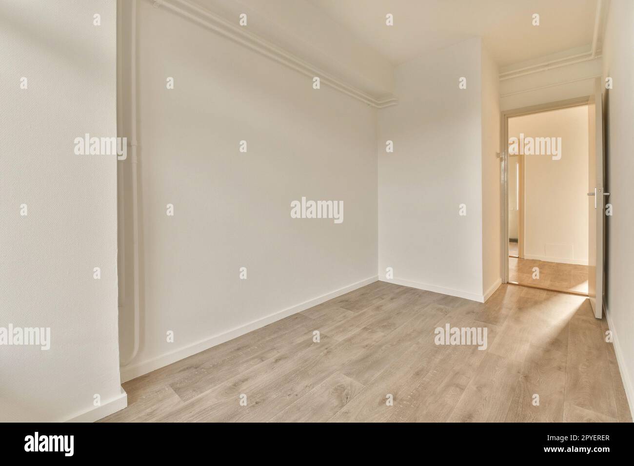 an empty room with white walls and wood flooring on the right hand side ...