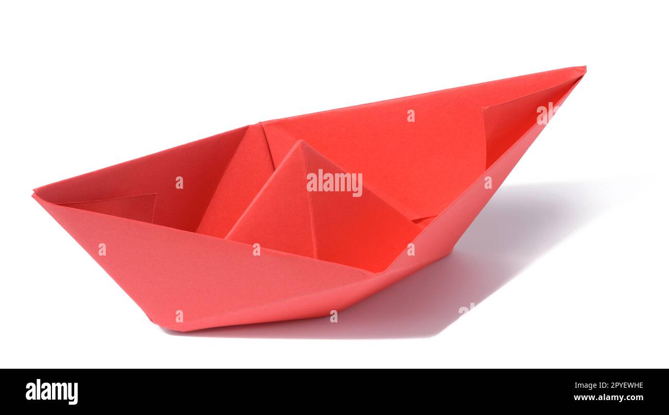 Red paper boat on a white isolated background Stock Photo