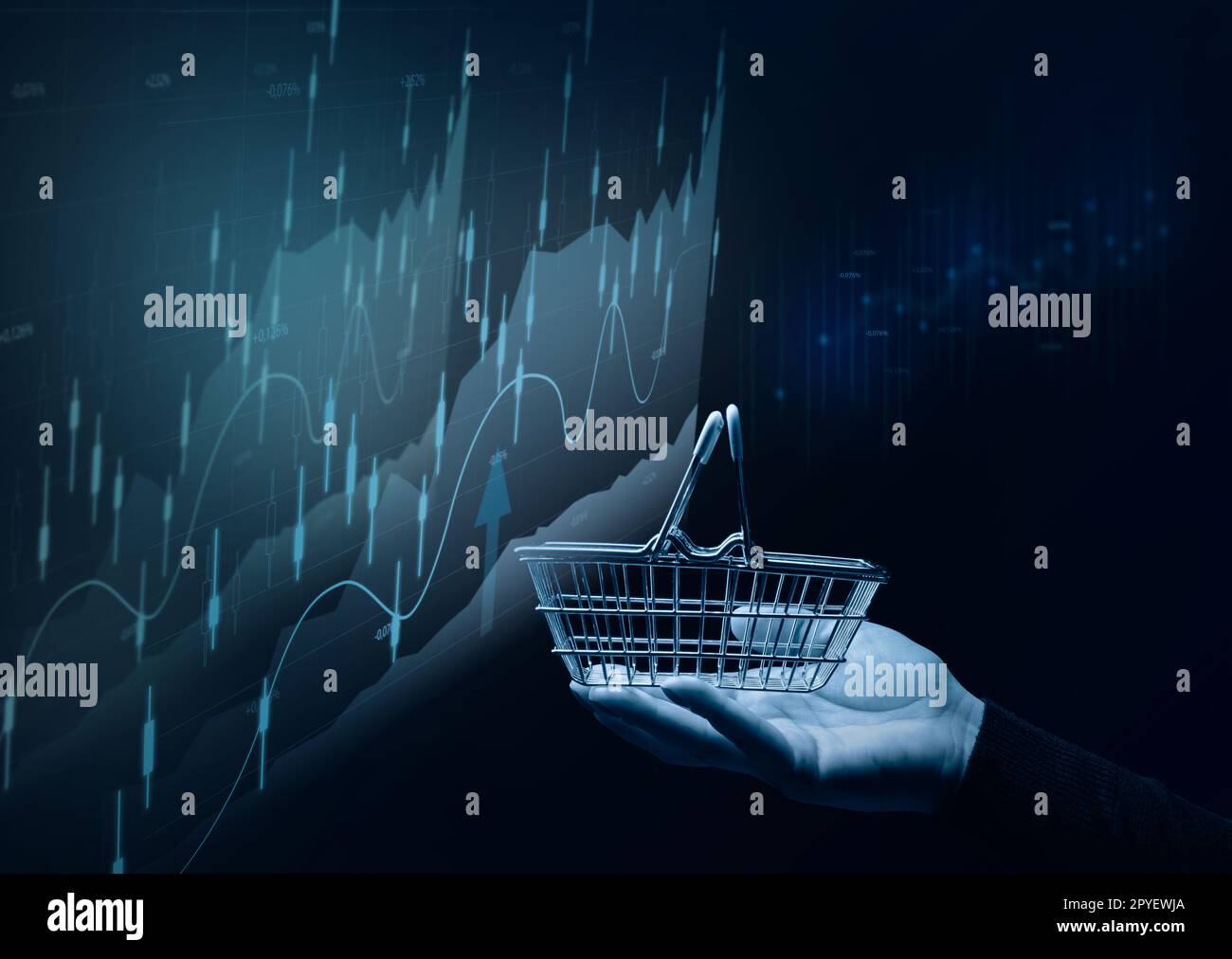 A female hand holding a miniature shopping basket and a chart with