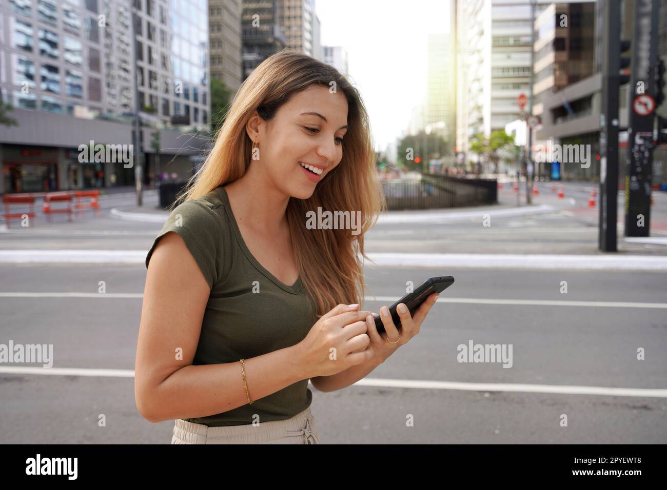 Attractive Brazilian woman using mobile phone on Paulista Avenue, Sao Paulo, Brazil Stock Photo