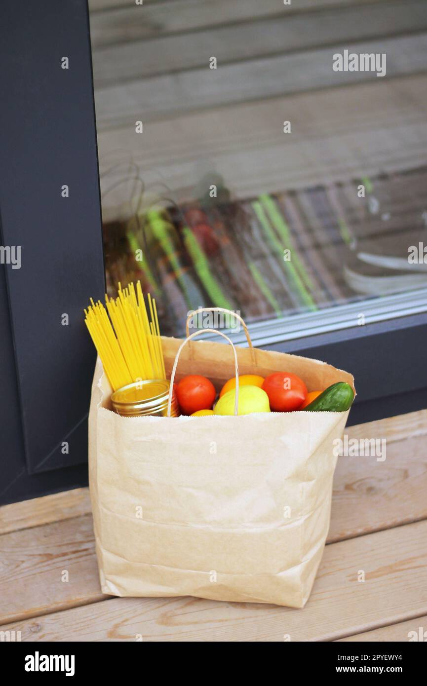 Quarantine contactless delivery, paper bag near the door Stock Photo