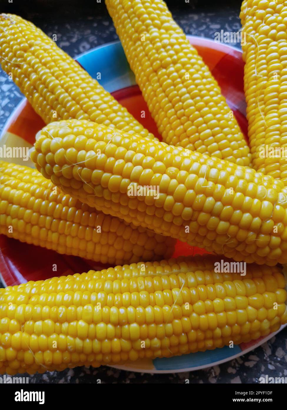 Boiled juicy corn on a plate Stock Photo