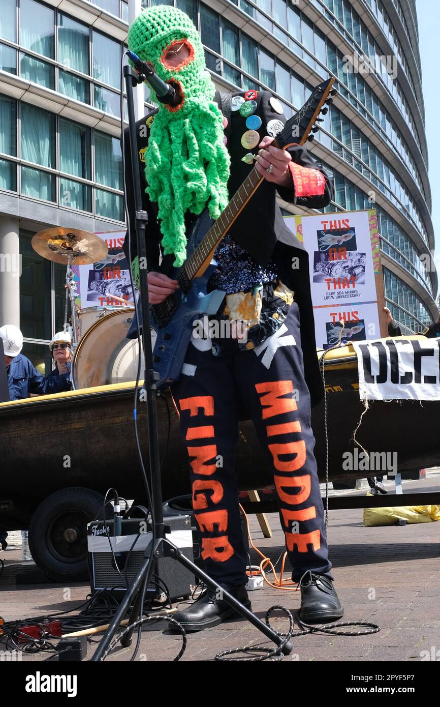 London, UK. 3rd May, 2023. Environmental activist group Ocean Rebelllion staged a heavy metal performance protest with Dutch band 'The Polymetallic Nodules' outside the venue hosting the two-day Deep Sea Mining Summit in Canary Wharf. The group opposes deep sea mining projects with grave concerns it would cause environmental harms including the destruction of sea beds and marine habitats - as well as water pollution during the process of extracting minerals. Credit: Eleventh Hour Photography/Alamy Live News Credit: Eleventh Hour Photography/Alamy Live News Stock Photo